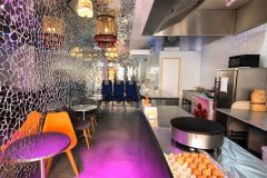 Interior of Disco Crêpes in Paris with mirrored walls, professional crepe stations and seating area.
